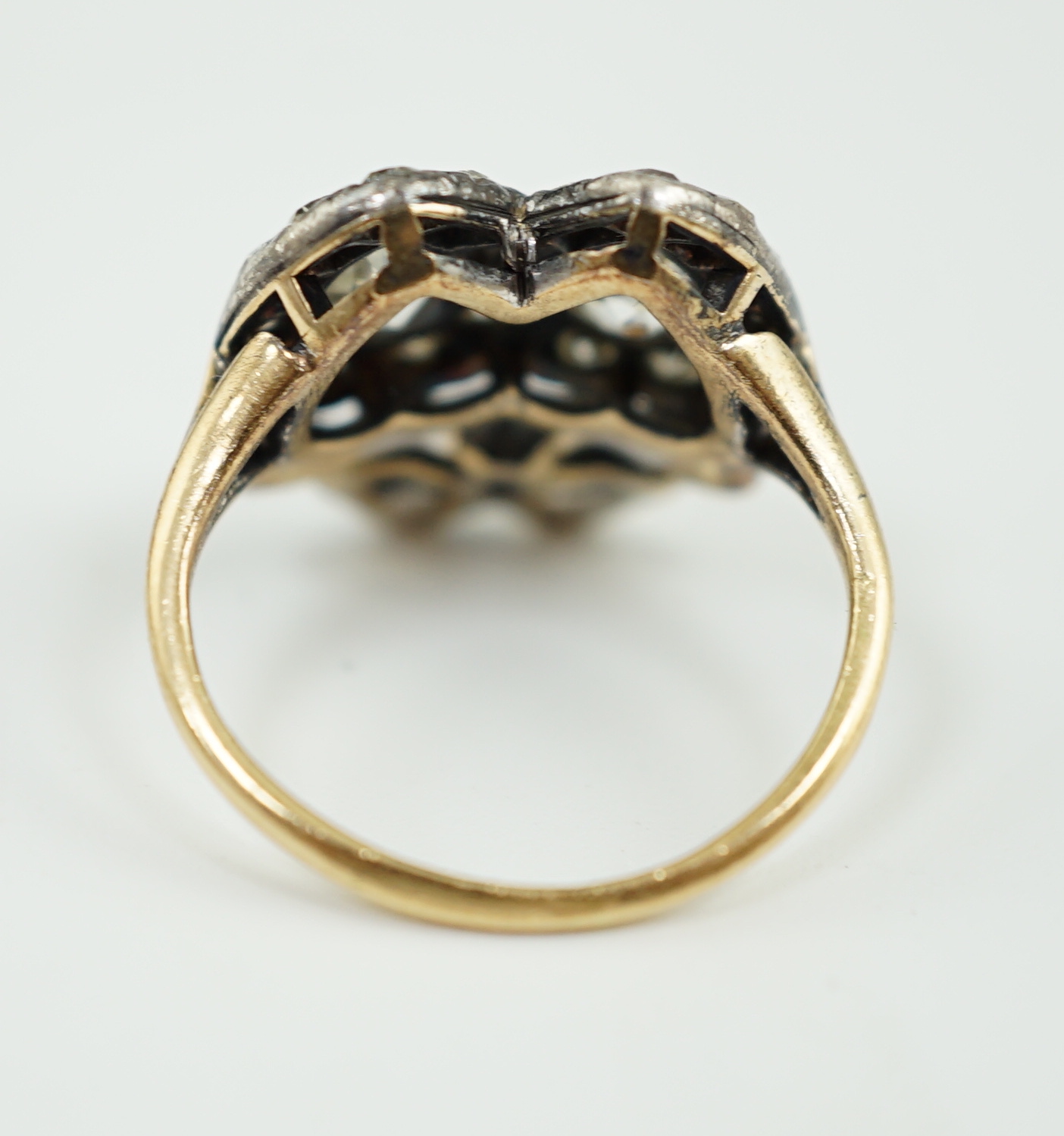 A 19th century gold, silver and diamond cluster set twin hearts ring, with ribbon bow surmounted